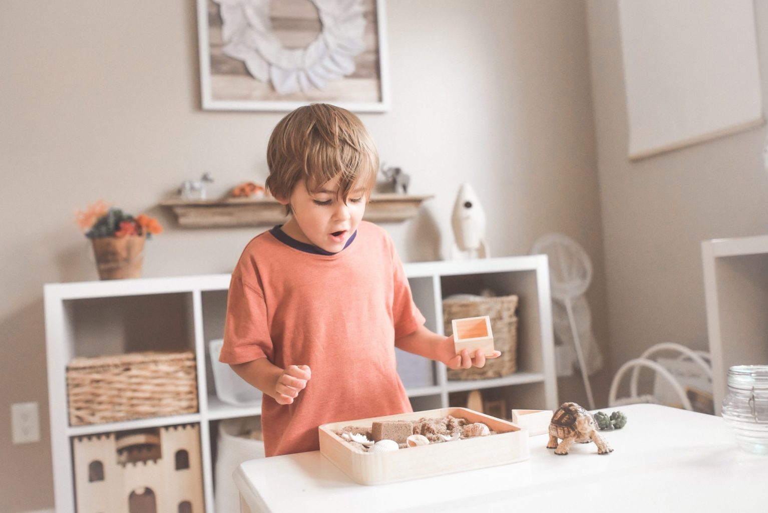 boy holding wooden blocks